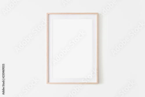 Portrait large 50x70, 20x28, a3,a4, Wooden frame mockup on white wall. Poster mockup. Clean, modern, minimal frame. Empty fra.me Indoor interior, show text or product photo