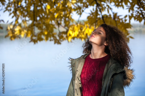 Curly hair teen girl standi...