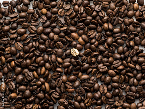 Coffee beans pattern with gold coffee bean in the centre at white background.