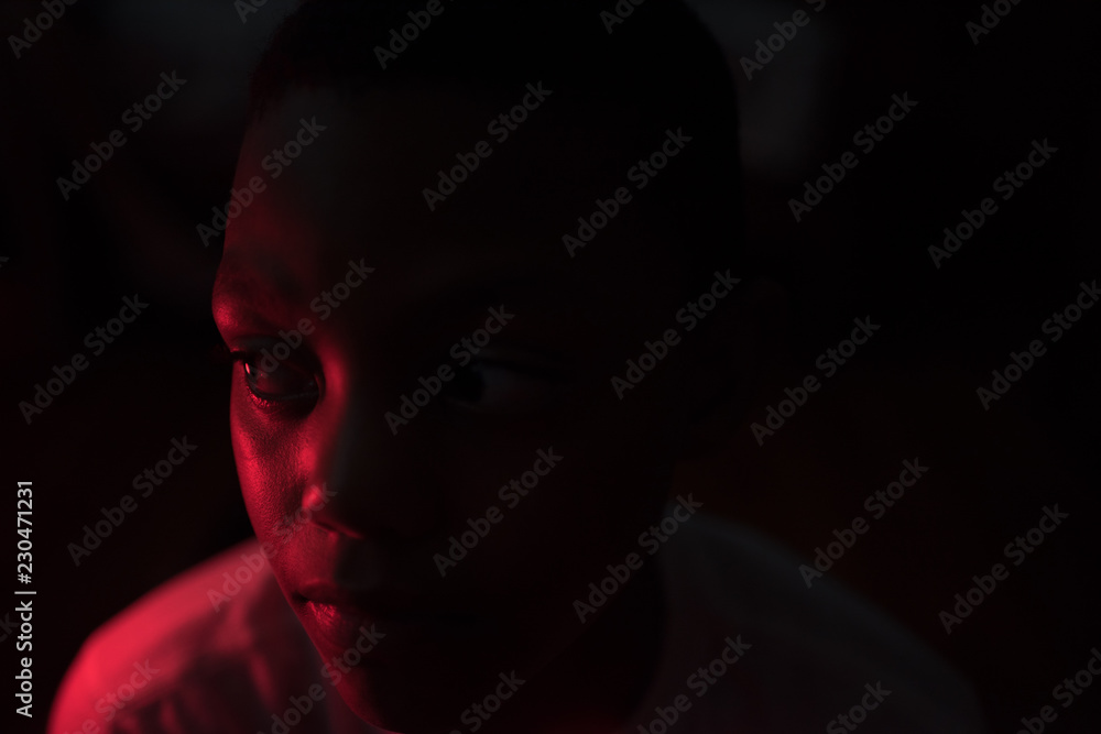 Boy staring in dark Boy staring in dark
