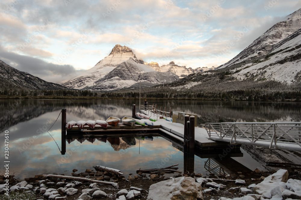 Warm dawn light on Mtt Henkel and the canoe dock after a snow storm. Glacier National Park, Montana
