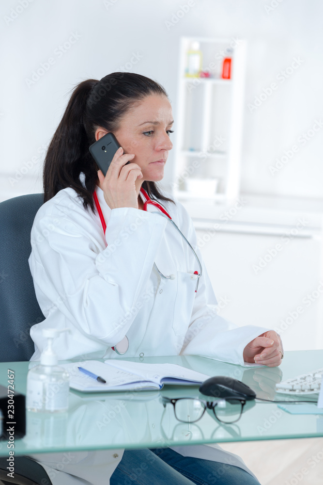 beautiful young female doctor sitting at the desk beautiful young female doctor sitting at the desk