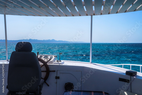 Steering wheel of an old yacht. White ship and captain's cabin view of the ocean, sea. Stock photo for tourist design © subjob