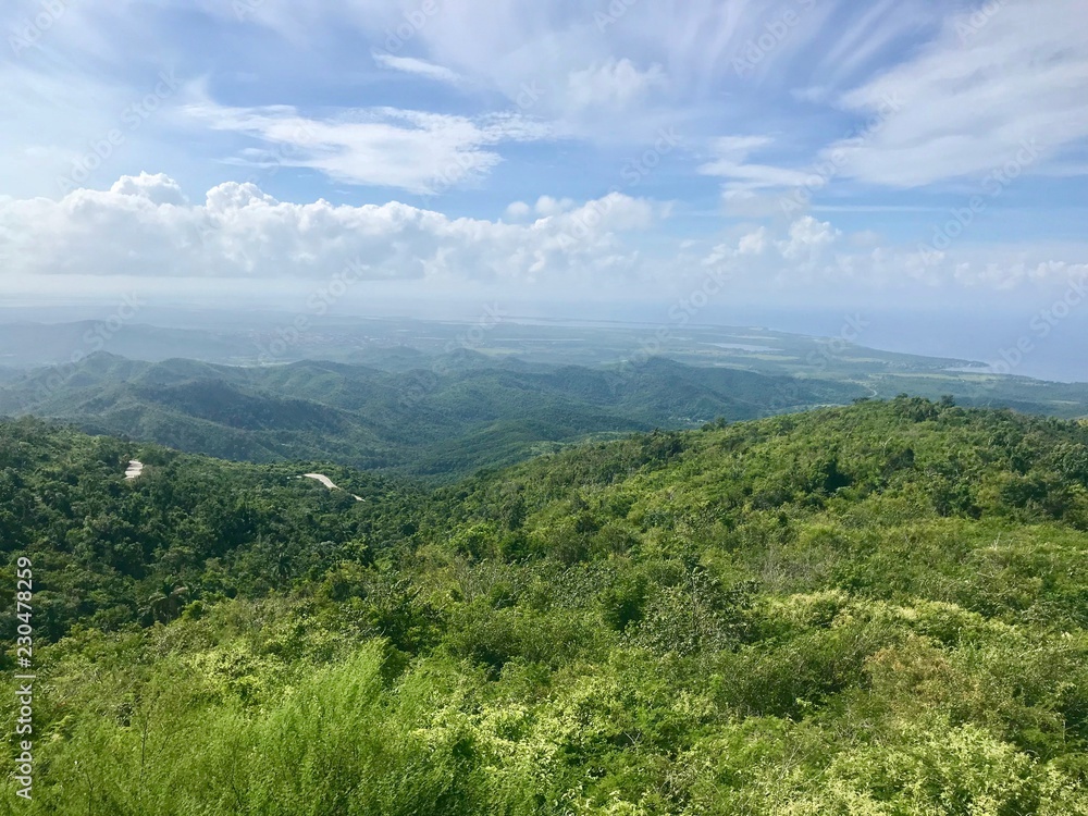 Mirador Lookout Point Panorama View close to Trinidad (Sancti Spiritus) in the Cuban Countryside (Caribbean island) with an untouched lush green vegetation and a blue summer sky with white clouds	