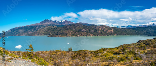 Fototapeta Naklejka Na Ścianę i Meble -  Panoramic view of Torres del Paine National Park, its forests, lagoon and glaciers at Autumn, Patagonia, Chile, sunny day, blue sky