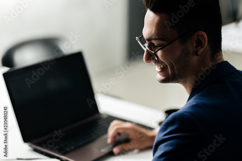 Professional architect dressed  in a business suit  works on the laptop in the office