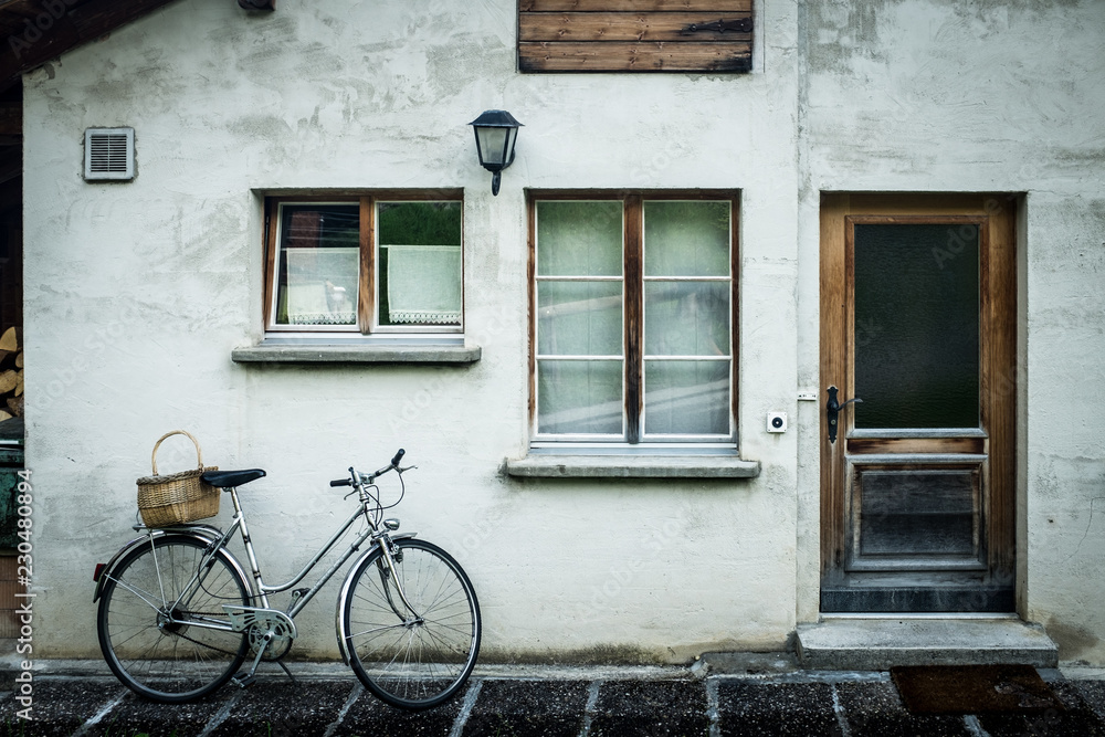 Bike leaning outside home in Swiss Alps