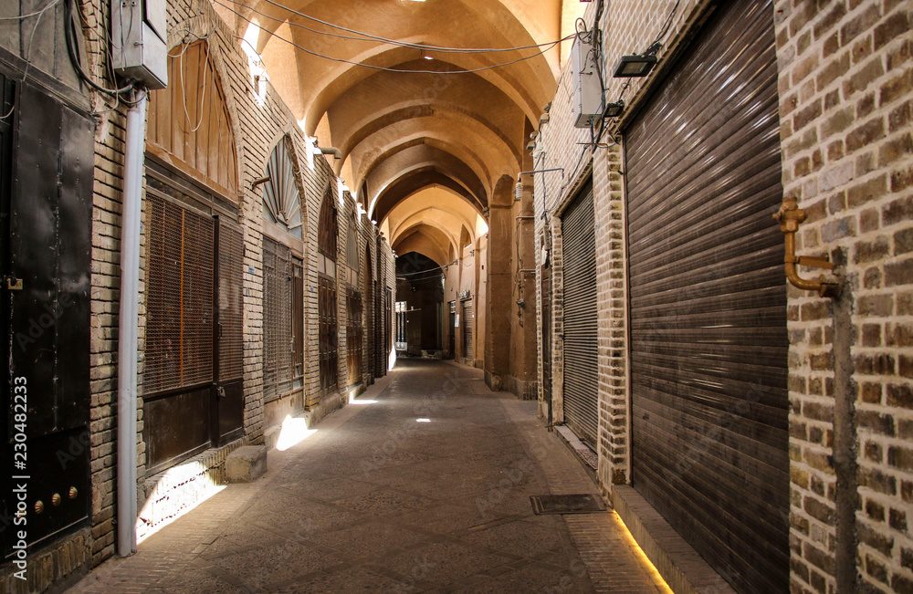 Street of the Yazd Khan bazar empty and deserted, in a covered alley of the market of the city Yazd, Iran