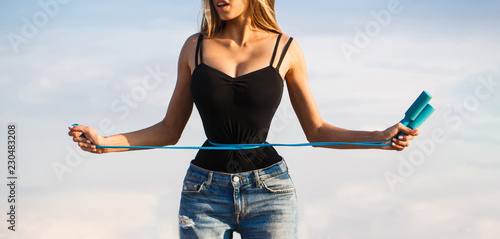 Картината върху платно Fit fitness girl measuring her waistline with measure tape