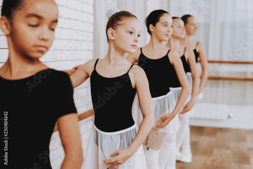 Ballet Training of Group of Young Girls Indoors.
