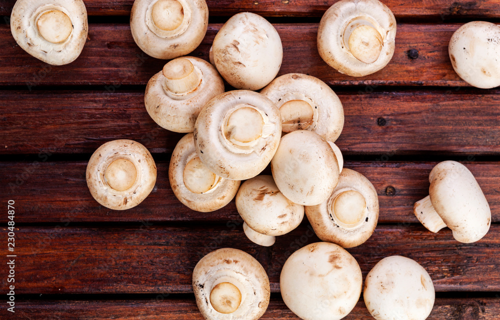 Fresh champignon mushrooms on wooden table, top view. Copy space Fresh champignon mushrooms on wooden table, top view. Copy space
