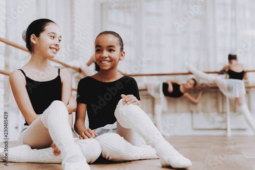 Girls Resting after Ballet Training on Floor.