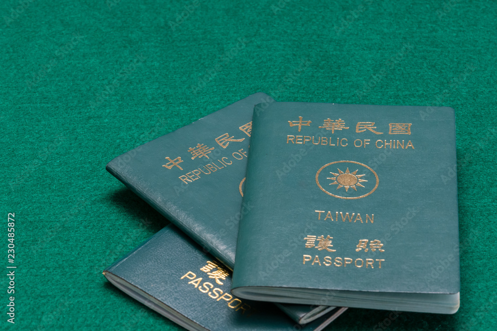 Taiwanese passports on green table Taiwanese passports on green table