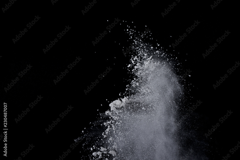 White powder explosion on black background. Dust splatted isolated. Paint Holi. White powder explosion on black background. Dust splatted isolated. Paint Holi.
