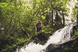 The girl is near the waterfall and the rocks. The Ukrainian picturesque Carpathians. Mountain trip. Traveling with friends. Landscapes from the top. Trees. Autumn