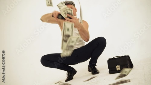An old fashioned squatting slav in a tank top and a baker boy cap sitting with a cigarette throwing money away
