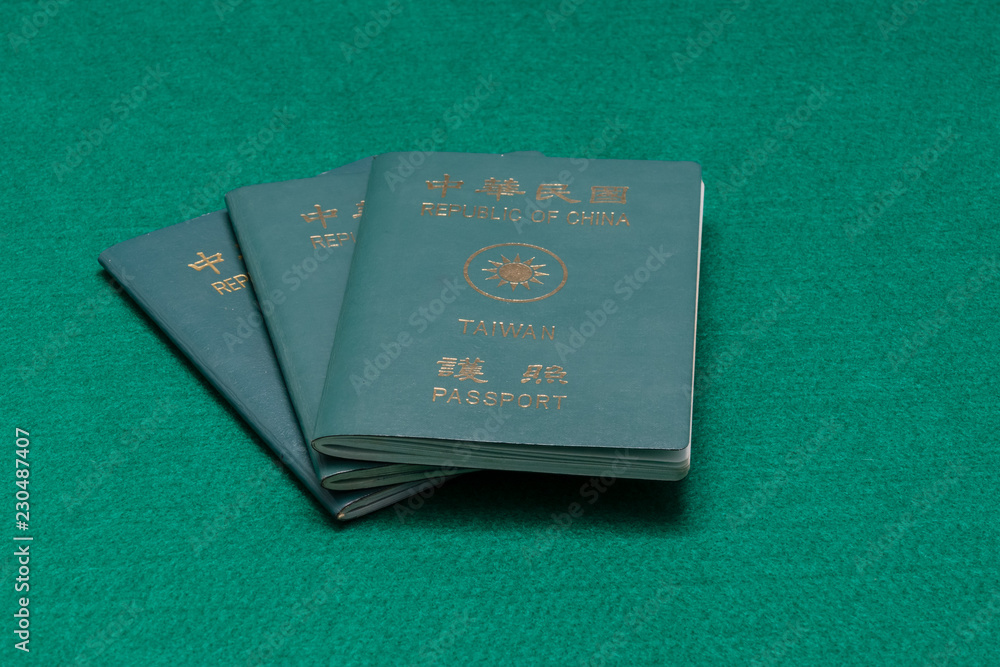 Taiwanese passports on green table Taiwanese passports on green table