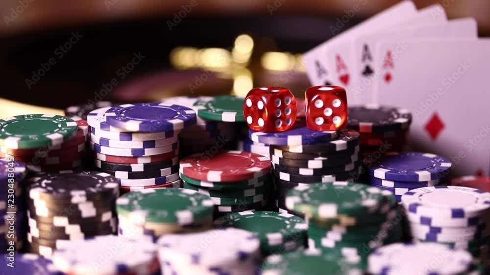 Poker Chips on gaming table, roulette wheel in motion Poker Chips on gaming table, roulette wheel in motion