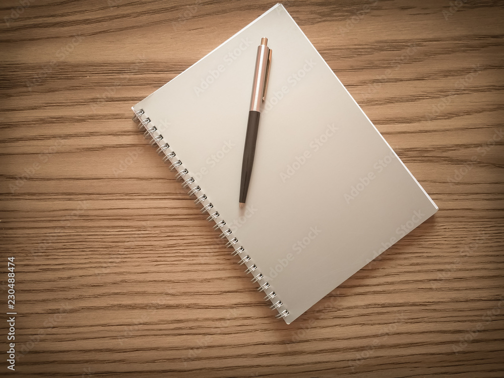 Blank note paper with pen on the wooden table Blank note paper with pen on the wooden table