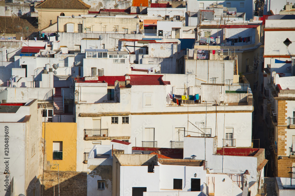 The whitewashed buildings of Cadiz, Spain compressed together by a zoom lens in an aerial photograph.