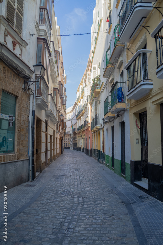 A medieval street, empty of crowds, in the city of Cadiz, Spain.