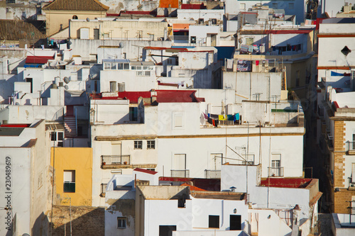 The whitewashed buildings of Cadiz, Spain compressed together by a zoom lens in an aerial photograph. © Jason Yoder