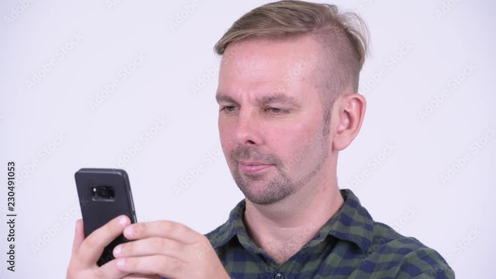 Portrait of happy blonde hipster man using phone Portrait of happy blonde hipster man using phone