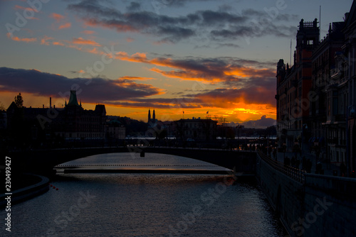 Evening view of Stockholm harbour with shilouettes of old town, parliament and famous landmarks photo