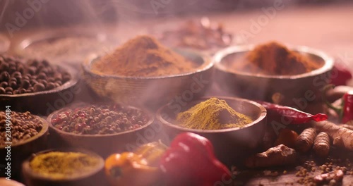 Smoke, Aromatic spices on wooden background photo