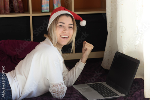 Woman with a laptop on Christmas holidays photo