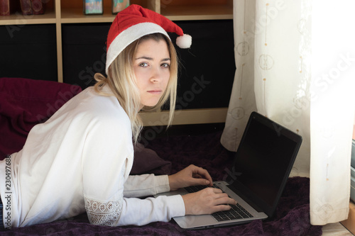 Woman with a laptop on Christmas holidays photo