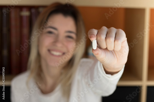 Young girl taking a pill photo