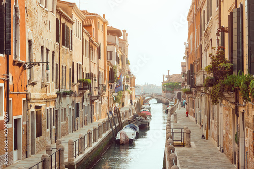 Venice, beautiful romantic italian city on sea with great canal and gondolas. View of venetian narrow canal. Venice is a popular tourist destination of Europe. © Buyanskyy Production