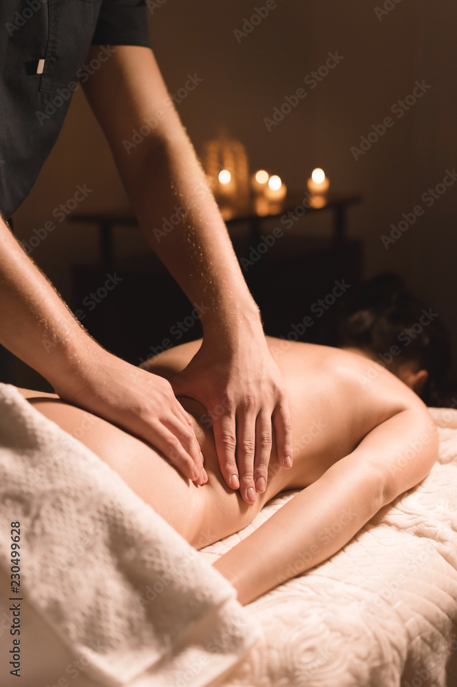 Fototapeta premium Close-up of male hands. Masseur does massage for the waist of a young girl. Rehabilitation, beauty therapy medicine. healthy concept