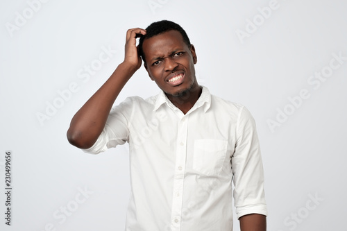 Nervous doubtful african male having puzzled look going to make serious decision.