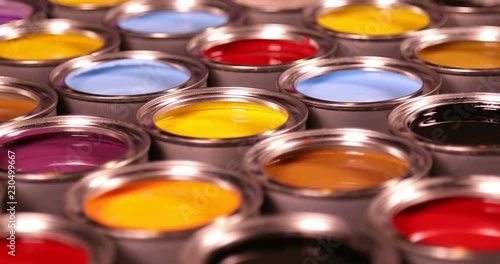 Buckets full of rainbow colored oil paint