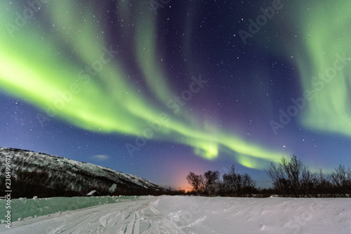 Beautiful green northern lights in the blue sky