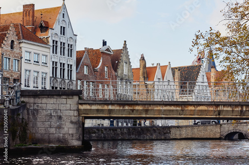 View of water canal, bridge and medieval architecture of Bruges