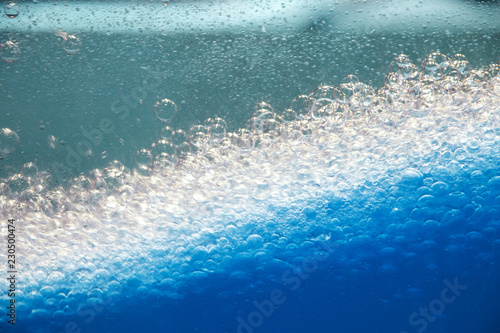Abstract background and texture of blue bubbles with backlight
