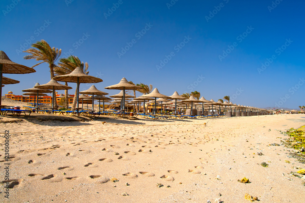 beach with chairs and umbrellas beach with chairs and umbrellas