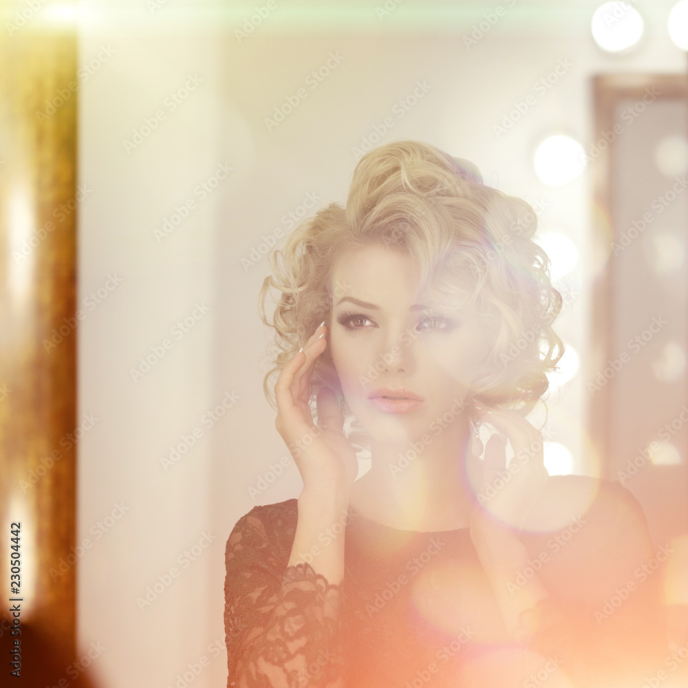 Beauty young model woman in luxurious evening dress in a fairy luxury apartment. Beautiful makeup and hairstyle. Classic vintage home interior. Light rays of a nightclub. Beauty young model woman in luxurious evening dress in a fairy luxury apartment. Beautiful makeup and hairstyle. Classic vintage home interior. Light rays of a nightclub.
