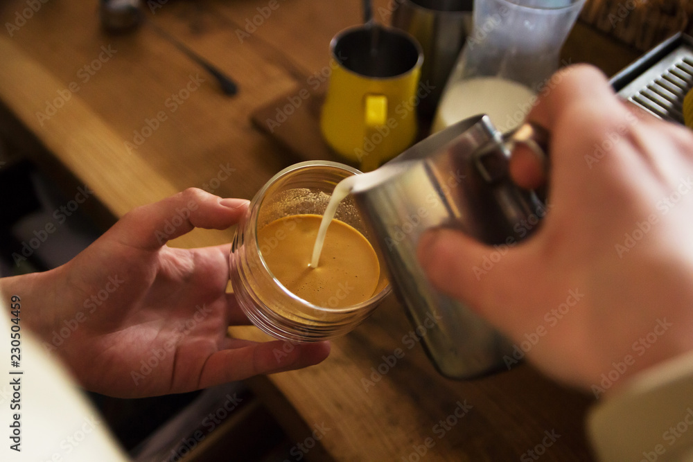 man's hand pouring coffee into cup glass man's hand pouring coffee into cup glass