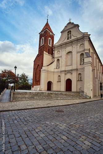 Baroque facade of the church with a Gothic bell tower in Gniezno.