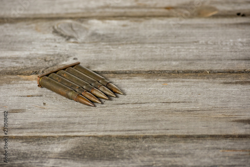 Clip with cartridges7,92 x 57 - isolated rustic ammos on the wooden background