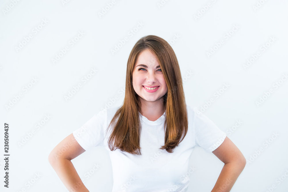 Portrait of happy laughing girl with squinting eyes flirting at camera isolated on white background. Young, emotional, surprised woman. Human emotions, positive facial expression concept. Copy space. Portrait of happy laughing girl with squinting eyes flirting at camera isolated on white background. Young, emotional, surprised woman. Human emotions, positive facial expression concept. Copy space.