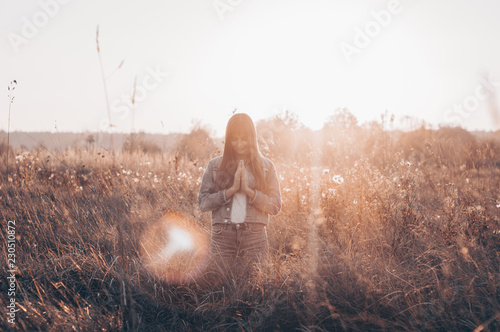Canvas Print girl closed her eyes, praying outdoors, Hands folded in prayer concept for faith, spirituality and religion