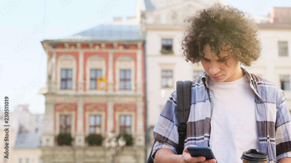 Happy guy using mobile in the street. Communication concept. Happy guy using mobile in the street. Communication concept.