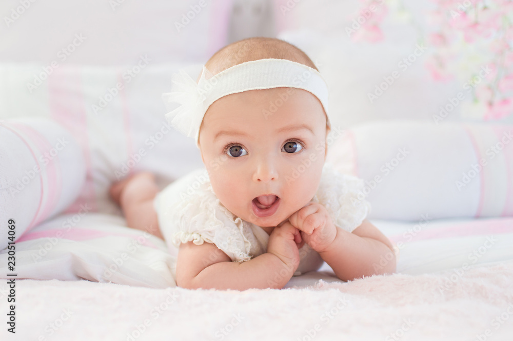Portrait of a crawling baby on a bed in his room. The concept of a happy child. Diapers. Portrait of a crawling baby on a bed in his room. The concept of a happy child. Diapers.