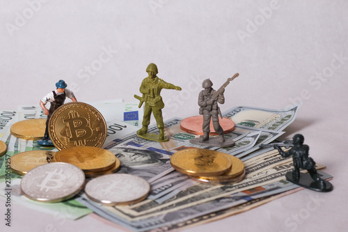 War of money concept. Bitcoin and worker miniatur photo