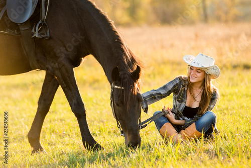 Girl equestrian rider equips horse